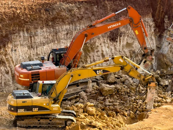 Two excavators working a cut