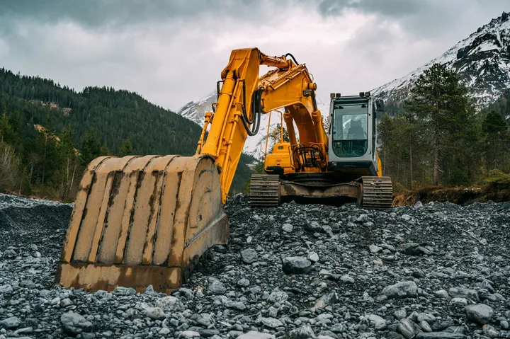 Excavator on rocky ground