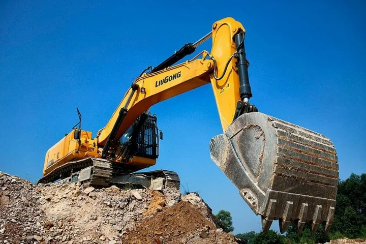 Yellow crawler excavator with its bucket raised