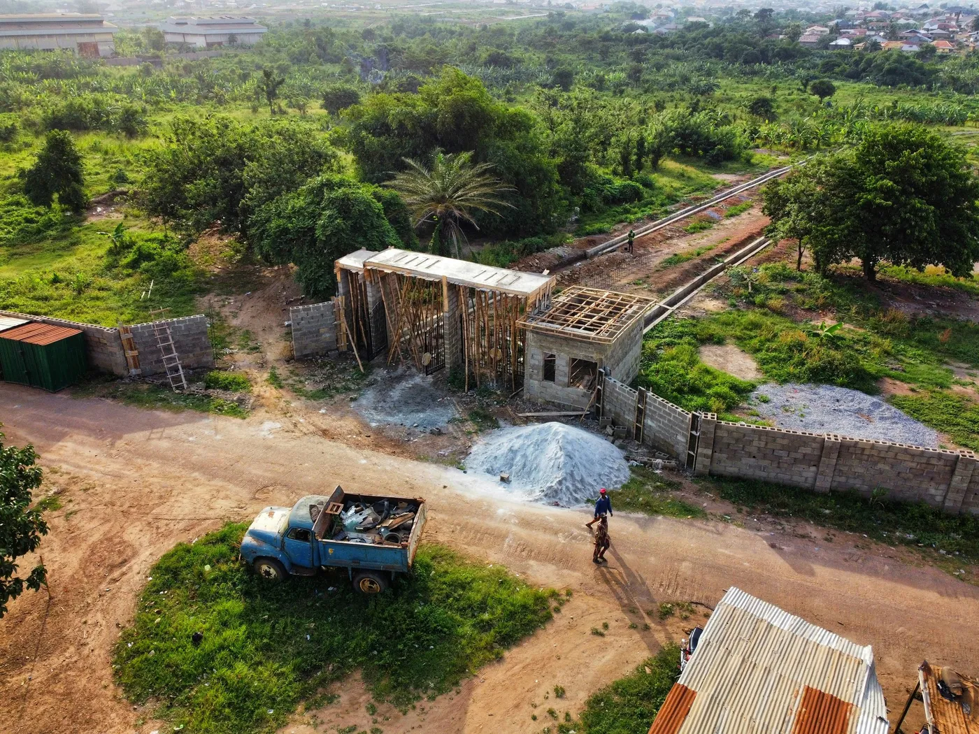 Building site from above with a tipper and a granite pile